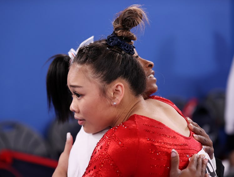 TOKYO, JAPAN - JULY 27: Sunisa Lee of Team United States is embraced by teammate Simone Biles during...
