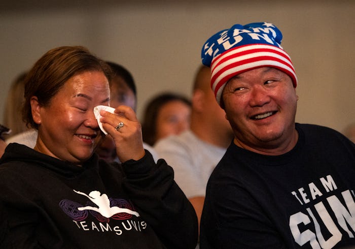 OAKDALE, MN - JULY 29: John Lee (R), Sunisa Lee's father, and Yeev Thoj react after Sunisa Lee of Te...