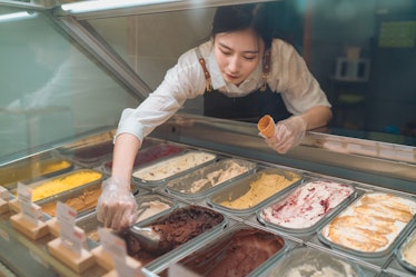 Beautiful gelato cafe staff scooping for a customer order