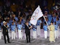 The governor of Tokyo Yuriko Koike waves the Olympic Flag as IOC President Thomas Bach and the mayor...
