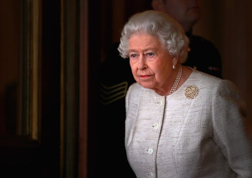 Queen Elizabeth II standing in a doorway.