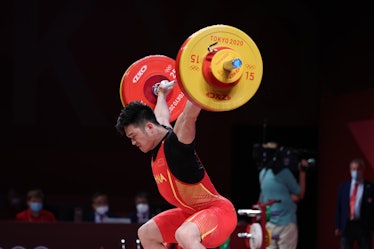 Shi Zhiyong of China competes during the men's 73kg weightlifting event of the Tokyo 2020 Olympic Ga...