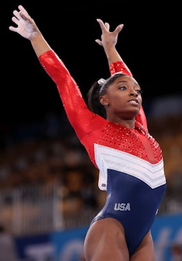 Simone Biles wearing a red, white, and blue leotard at the Olympics. 