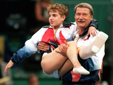 Kerri Strug being carried at the Olympics (Photo by Frank Kleefeldt/picture alliance via Getty Image...