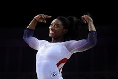 LONDON, ENGLAND - MARCH 23: Simone Biles of the USA reacts after finishing her her performance on ba...