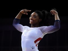 LONDON, ENGLAND - MARCH 23: Simone Biles of the USA reacts after finishing her her performance on ba...