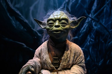 A life-size figurine of Yoda from the Star Wars series is displayed at the Star Wars Identities exhi...