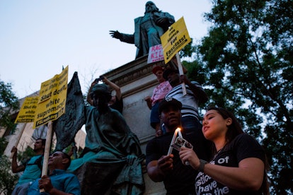 Demonstrators light candles in front of the statue of Confederate General Albert Pike on August 13, ...