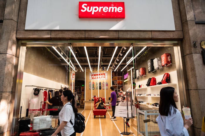 SHANGHAI, CHINA - 2019/09/07: Pedestrians walk past an American skateboarding shop and clothing bran...