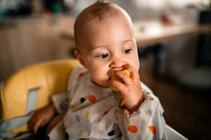 Cute baby girl with a rare name sitting in the high chair