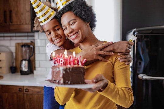 Photo of African American mother and daughter are at home, they are celebrating a birthday