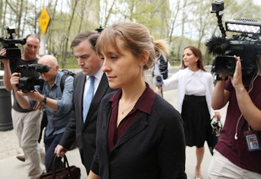 NEW YORK, NY - MAY 04:  Actress Allison Mack (C) departs the United States Eastern District Court af...