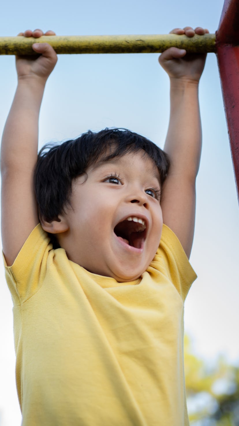 Beautiful asian Japanese little boy having fun at playground