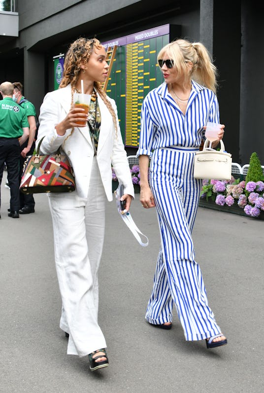 LONDON, ENGLAND - JULY 05: FKA Twigs (L) and Sienna Miller attend day 8 of Wimbledon 2021 at All Eng...