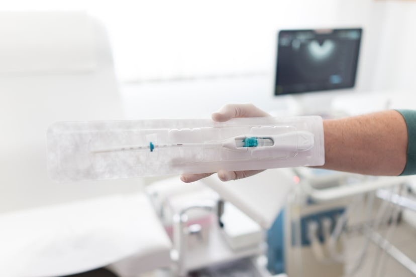 Doctor in hospital holding IUD