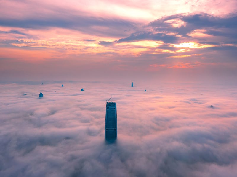 WUHAN, CHINA - JULY 05: Skyscrapers are surrounded by heavy clouds after a rainfall on June 5, 2021 ...