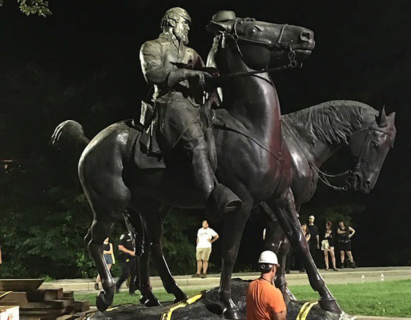 TOPSHOT - Workers load statues of Confederate generals Robert E. Lee and Thomas "Stonewall" Jackson ...