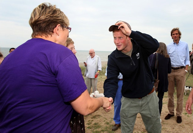 Prince Harry met with kayakers on a beach.