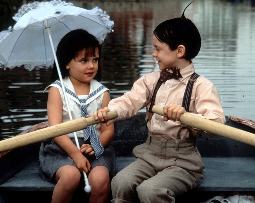 Bug Hall rowing a boat while looking at Brittany Ashton Holmes in a scene from the film 'The Little ...