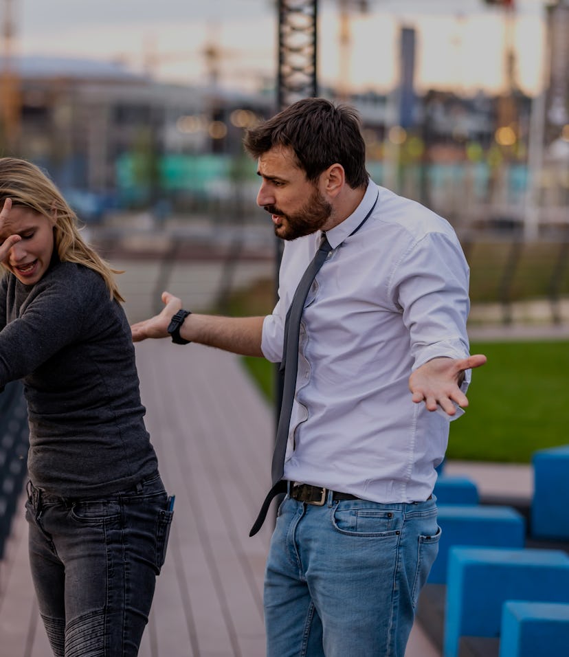 Handsome Young Man is Having Harsh Debate with his Beautiful Girlfriend with Long Hair while Taking ...