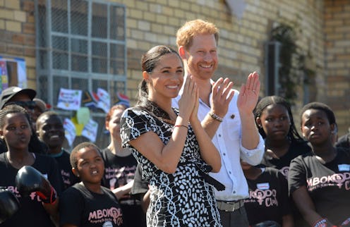 TOPSHOT - Prince Harry, Duke of Sussex and Meghan, Duchess of Sussex arrive for a visit to the "Just...