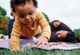 adorable baby boy playing in grass in article about one-syllable boy names