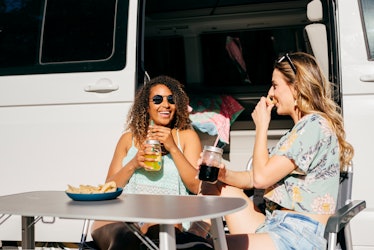 Women enjoying drinks and nachos outside of a van, having TikTok's viral boat dip.
