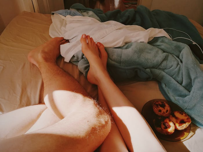couple's feet in bed together