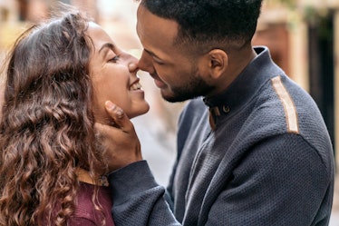 A photo of a young woman about to kiss a man with a beard, which can cause beard burn after kissing