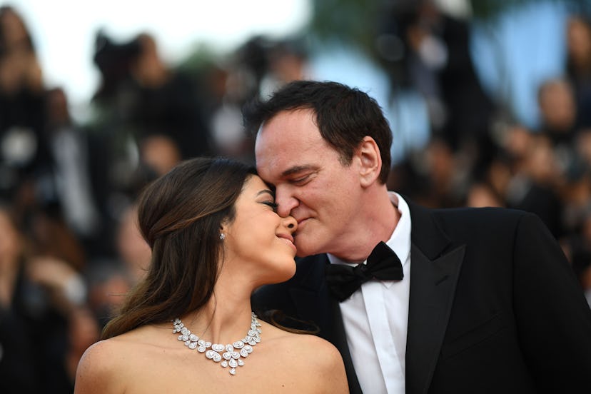 TOPSHOT - US film director Quentin Tarantino (R) kisses his wife Israeli singer Daniella Pick as the...