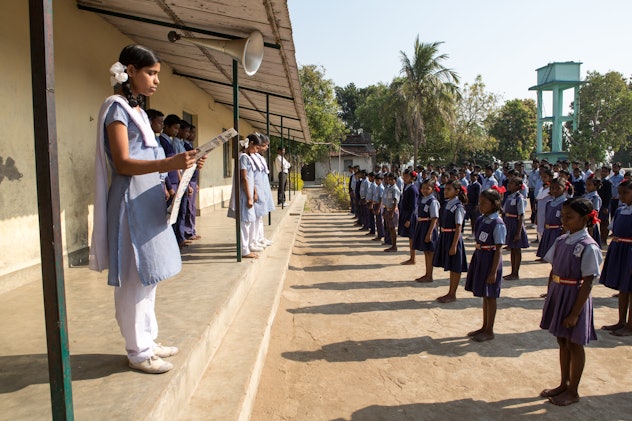 Karon, Indian, school students in navy jumpers with polo shirts underneath stand in organized lines ...