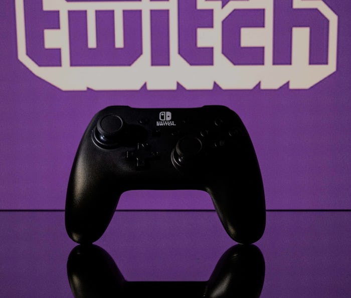 A gamepad is pictured as a screen displays the online Twitch plateform in Toulouse, southwestern Fra...