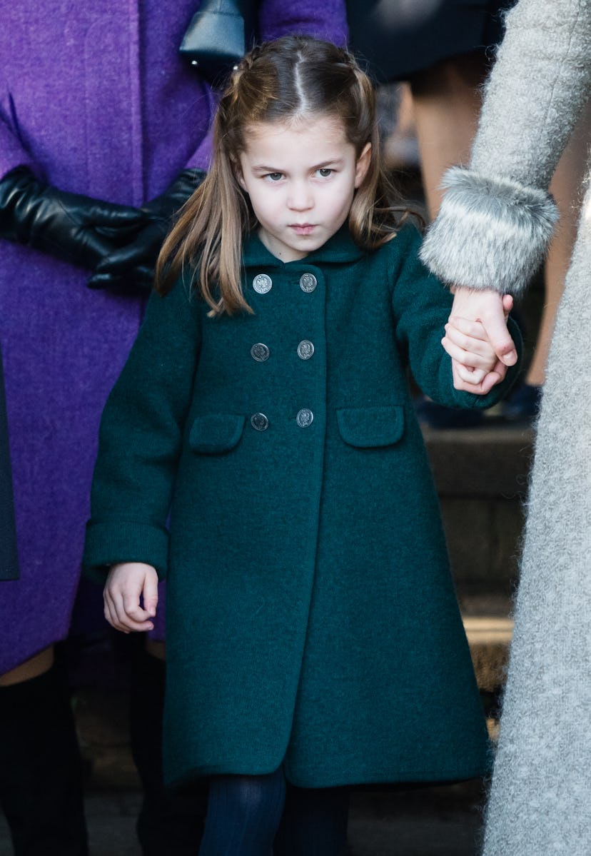 KING'S LYNN, ENGLAND - DECEMBER 25: Princess Charlotte of Cambridge is given a hug by a wellwisher a...