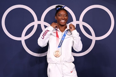 Simone Biles of Team United States poses with the bronze medal following the Women's Balance Beam Fi...
