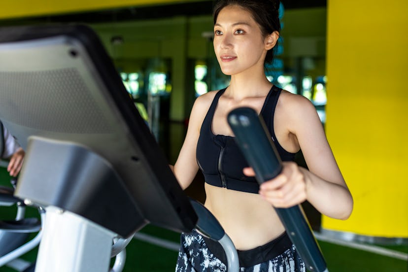 A person works out on an elliptical. Ellipticals can help ease soreness after a tough workout.
