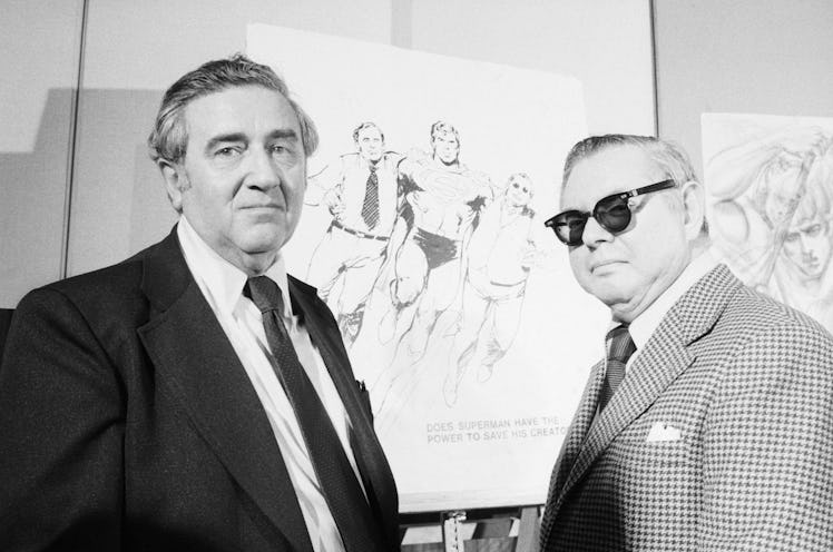 Superman creators Jerry Siegel and Joe Shuster pose in front of sketches of their creation