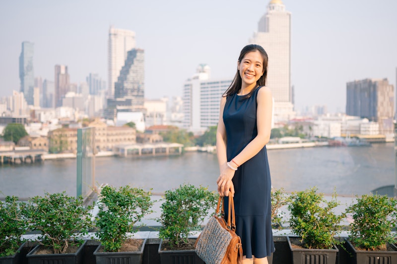 Asia worker business woman happy with hand bags enjoying relaxing at rooftop in evening after work i...