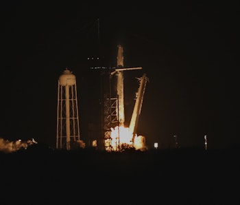 A SpaceX Falcon 9 rocket, carrying the Crew-2 mission astronauts, lifts off from launch complex 39A ...