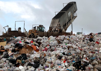 A truck dumps 20 tons of trash into a landfill. 