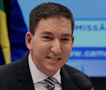 US journalist Glenn Greenwald, founder and editor of The Intercept website gestures during a hearing...