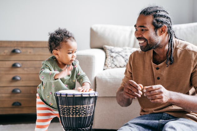 Dad playing with baby daughter