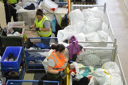 Workers sort donated clothing at the St Vincent de Paul Society, a major charity recycling clothes. 