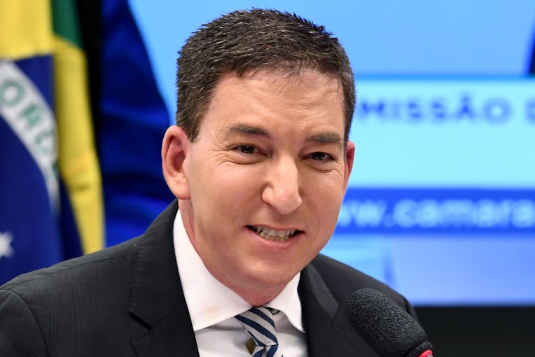 US journalist Glenn Greenwald, founder and editor of The Intercept website gestures during a hearing...
