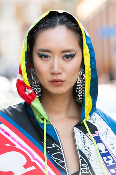 Betty Bachz wears blue and black graphic eyeliner and all Iceberg during London Fashion Week Men's J...