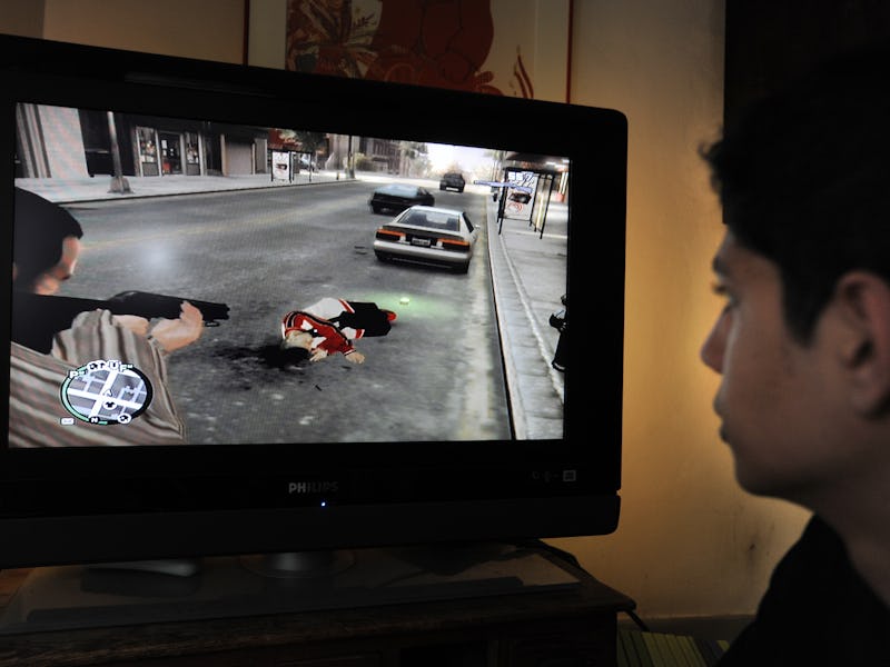 A teenager is playing with the new popular video game Grand Theft Auto IV that has been on the marke...