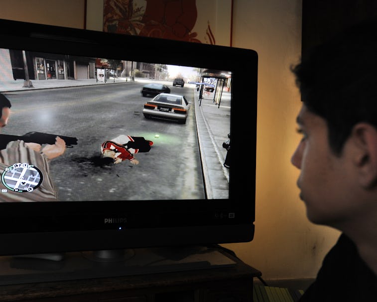 A teenager is playing with the new popular video game Grand Theft Auto IV that has been on the marke...