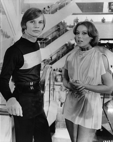 Michael York and Jenny Agutter ride an escalator in a scene from the film 'Logan's Run', 1976. (Phot...