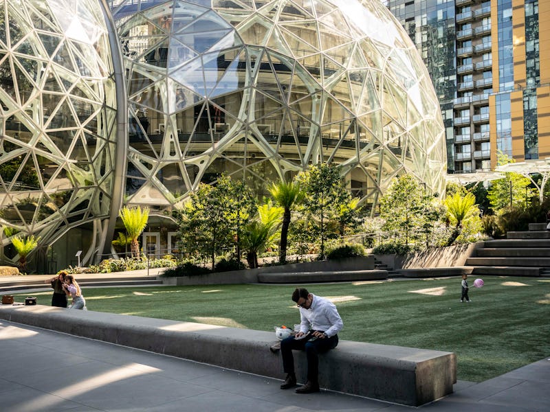 SEATTLE, WA - MAY 20: People use a common space outside of The Spheres at the Amazon.com Inc. headqu...