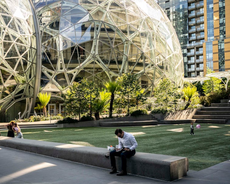 SEATTLE, WA - MAY 20: People use a common space outside of The Spheres at the Amazon.com Inc. headqu...