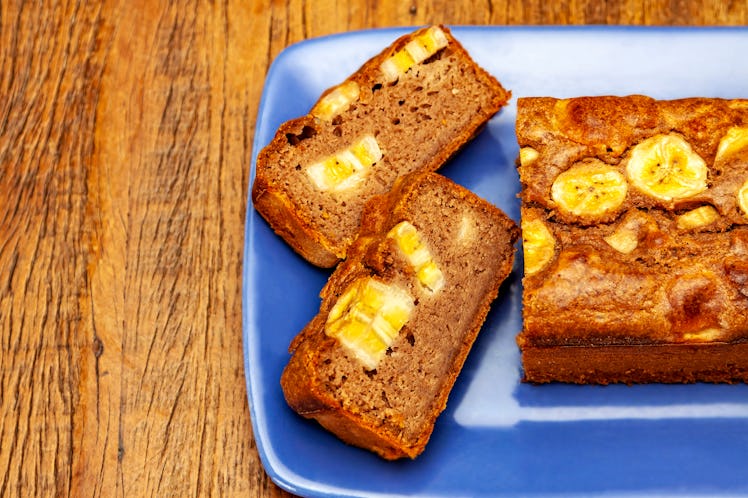 Two slices of banana bread on a blue plate, which you can make using these milk recipes.